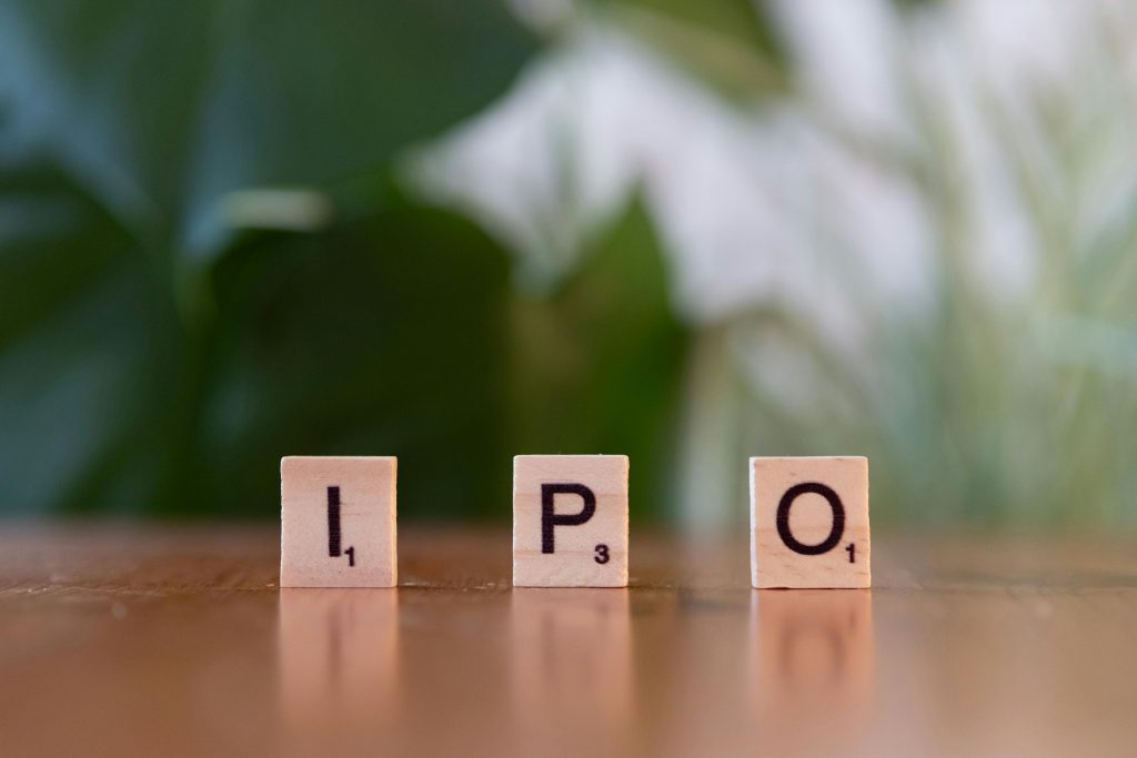 Wooden letter blocks spelling IPO on a table, symbolizing investment opportunities.